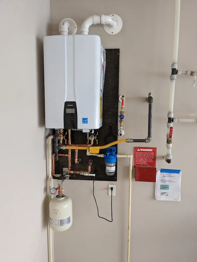 Professional plumber installing copper piping in a Bettendorf home